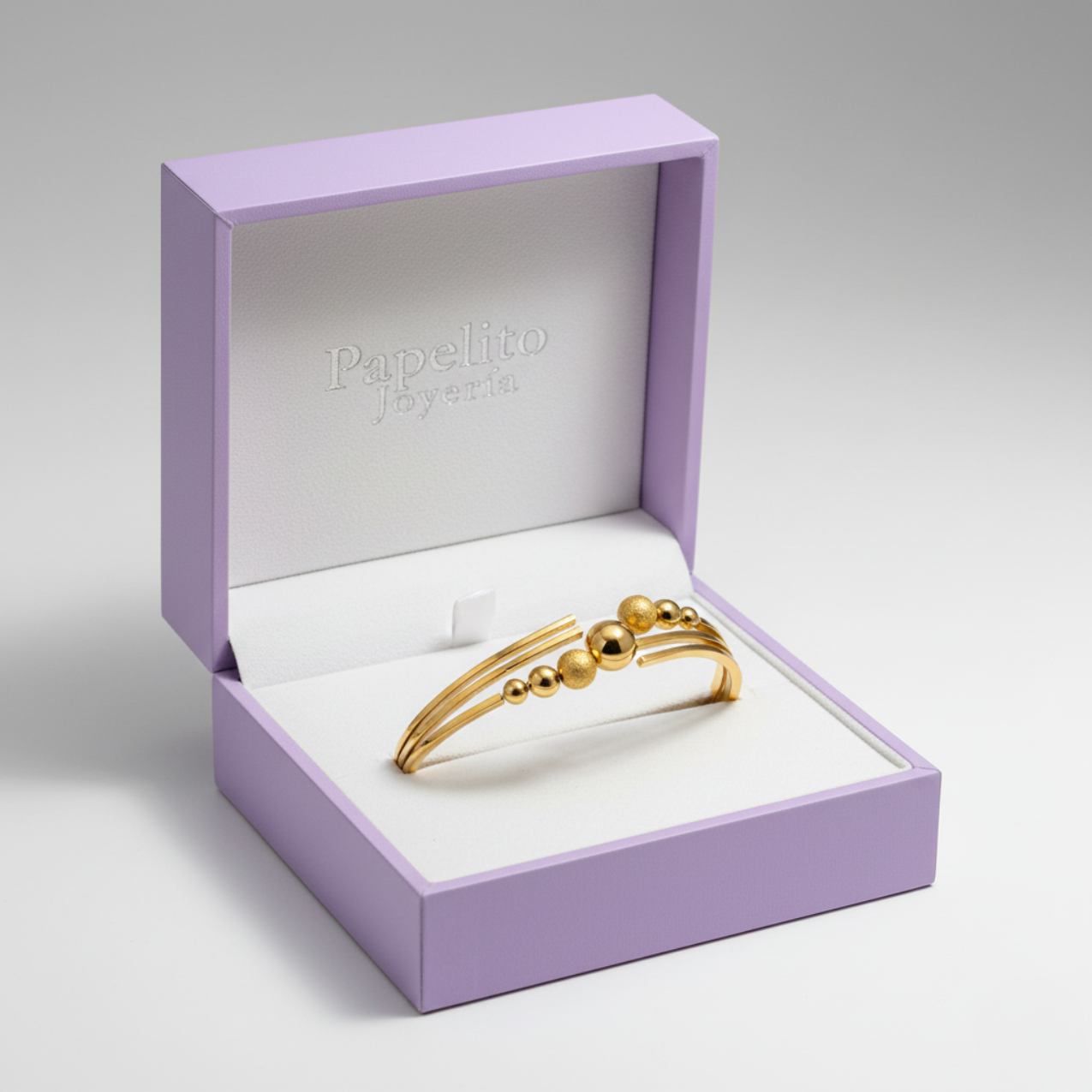 Brazalete Rígido Abierto de Acero Chapado en Oro 18K con Bolas Lisas y Texturizadas