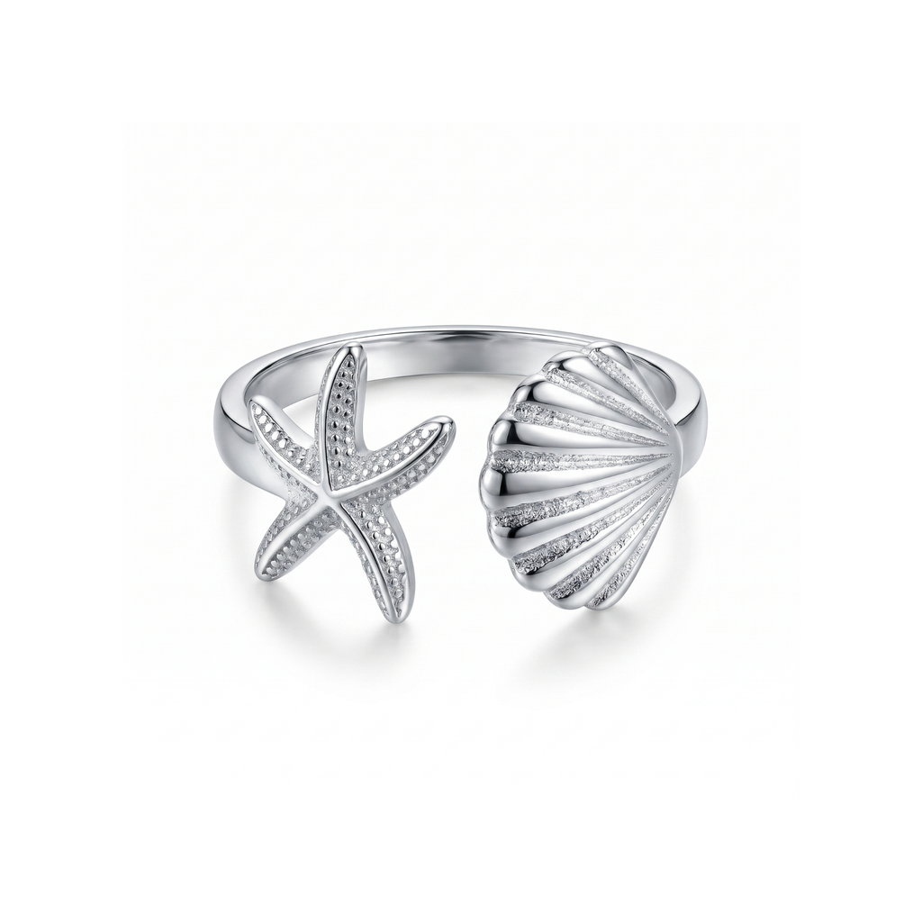 Anillo ajustable de acero con diseño abierto de estrella de mar y concha marina, acabado en plata, fabricado en España por Papelito.