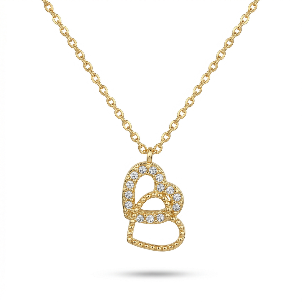 Collar de cadena fina con colgante de dos corazones entrelazados bañados en oro de 18K y detalles de cristales, marca Papelito, hecho en España.