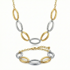 Conjunto de joyería de lujo bicolor compuesto por collar y pulsera de eslabones ovalados entrelazados. Fabricado en 100% acero inoxidable con baño de oro 18K y tono plateado. Hecho en Italia.