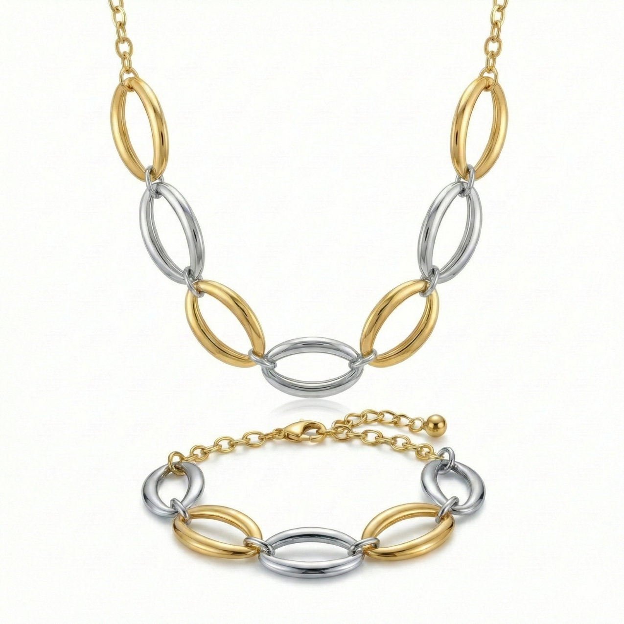 Conjunto de joyería de lujo bicolor compuesto por collar y pulsera de eslabones ovalados entrelazados. Fabricado en 100% acero inoxidable con baño de oro 18K y tono plateado. Hecho en Italia.