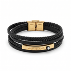 Brazalete multicapa para hombre con bandas de cuero negro trenzado y placa de acero con baño de oro 18K. Joyería masculina de diseño fabricada en España.