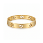 Pulsera rígida tipo bangle en acero inoxidable con baño de oro 18k y monograma circular calado hecha en España.