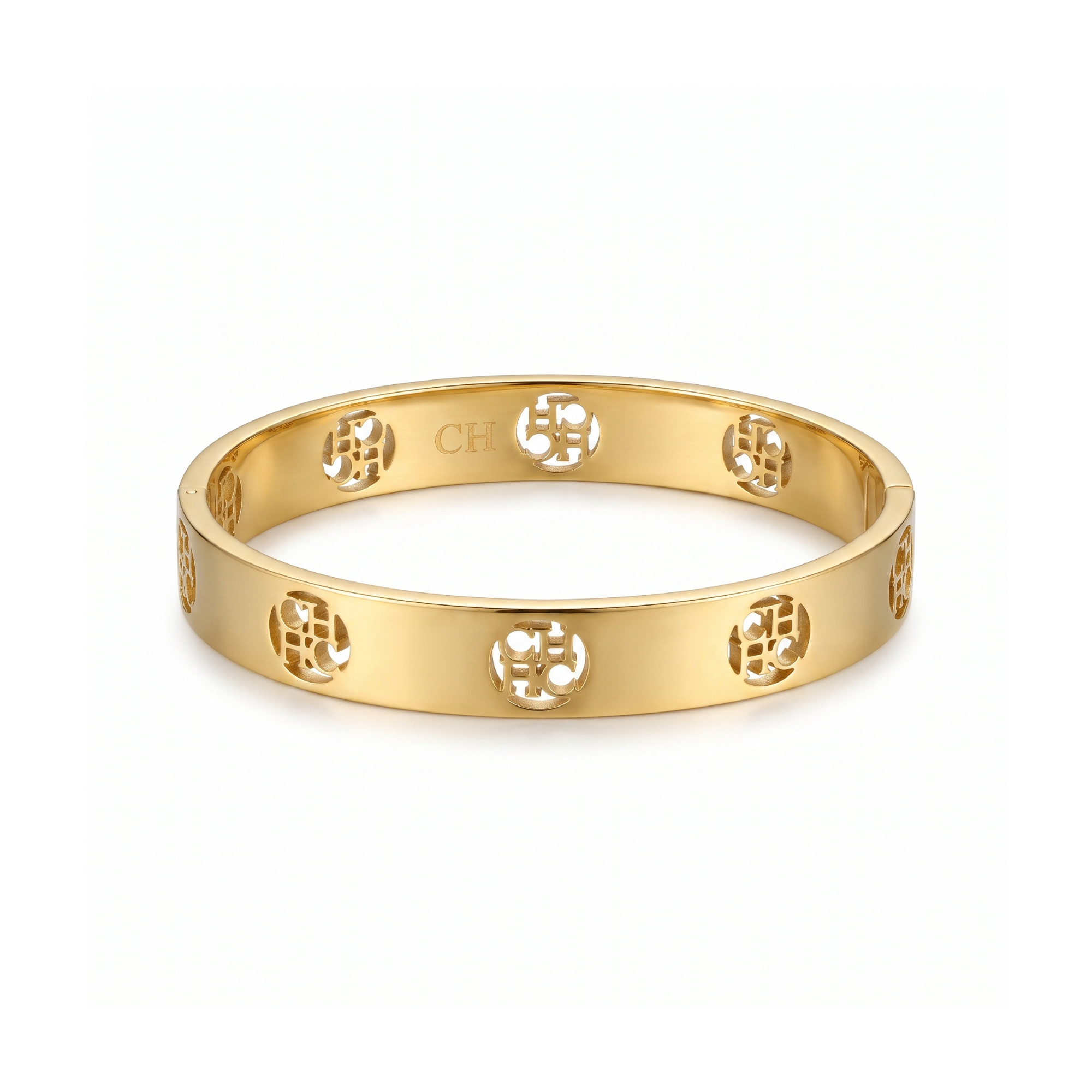Pulsera rígida tipo bangle en acero inoxidable con baño de oro 18k y monograma circular calado hecha en España.