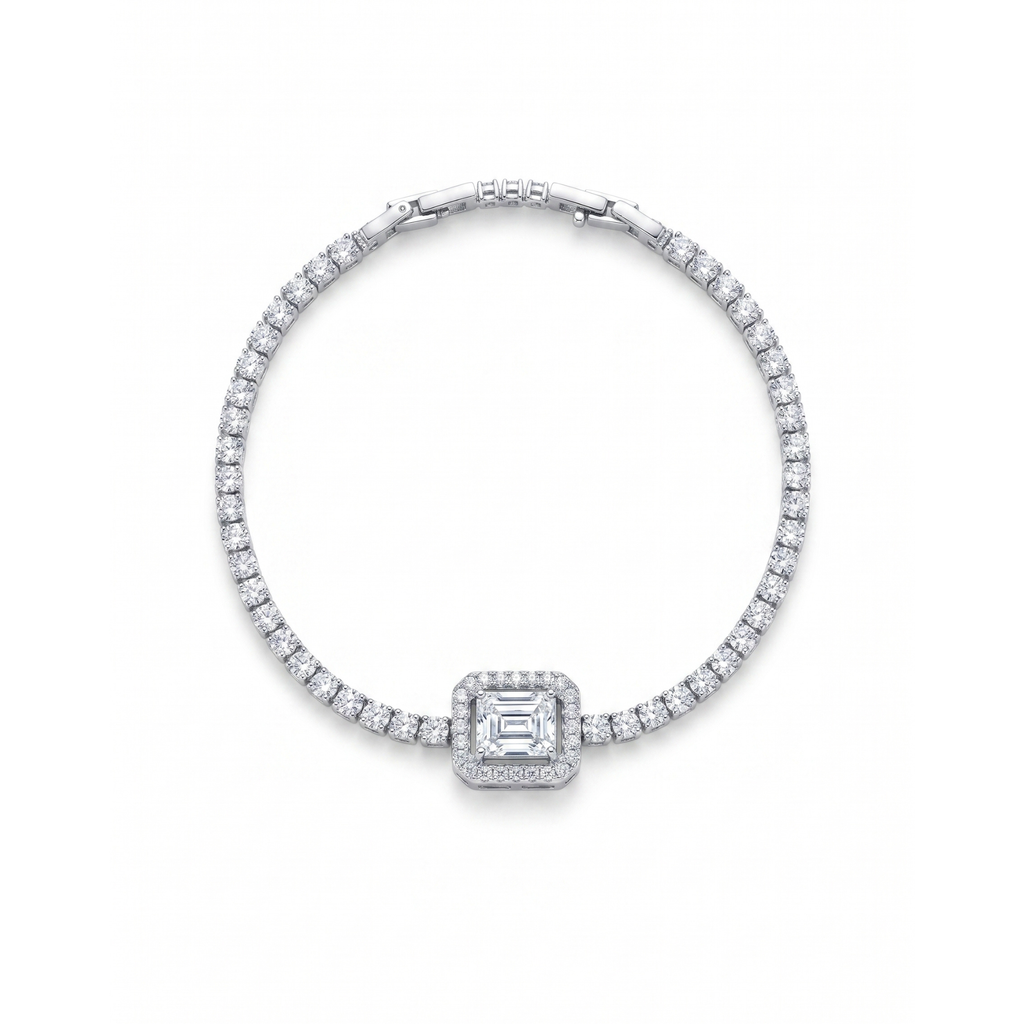 Pulsera estilo tenis en acero con baño de oro 18k PVD y piedra central corte esmeralda con halo de circonitas brillantes.