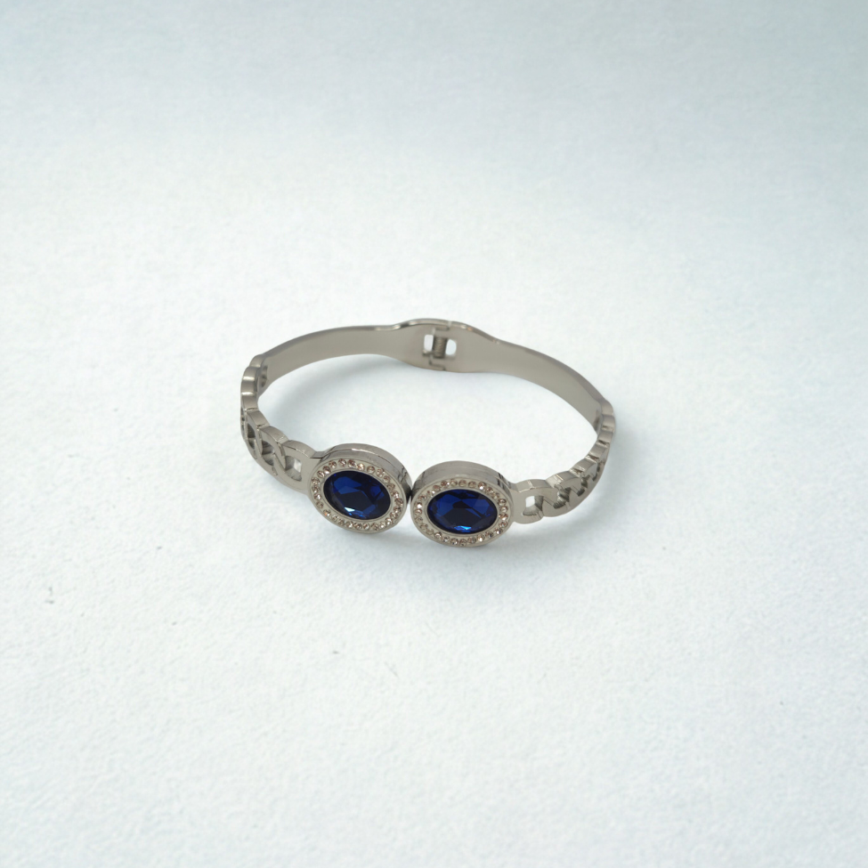 Bracelet rigide avec deux cristaux bleus ovales et zircones - 100 % acier rhodié