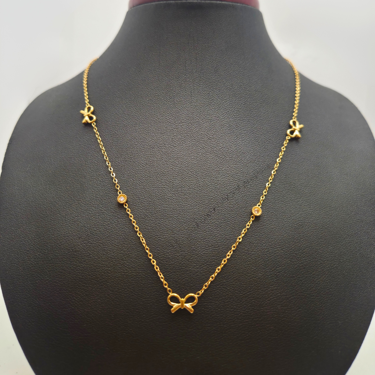 Collier avec nœuds et zircones 100 % acier plaqué or 18 carats