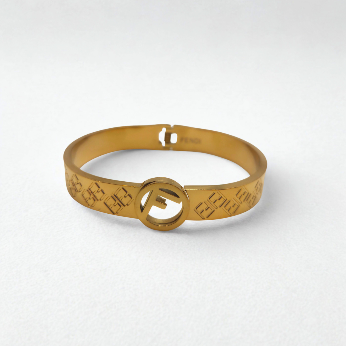 Pulsera Rígida con Patrón de Letras Entrelazadas y Círculo Central 100% Acero Bañado en Oro 18K